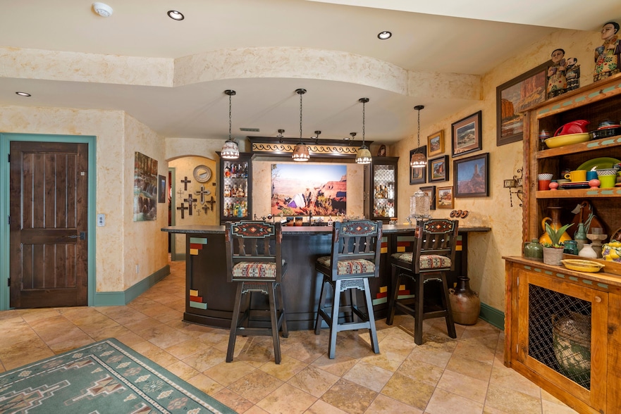 A bar anchors the Southwestern-themed lower level of the house that sits on the Kentucky side of the Ohio River. (Robinson Sotheby's International Realty)