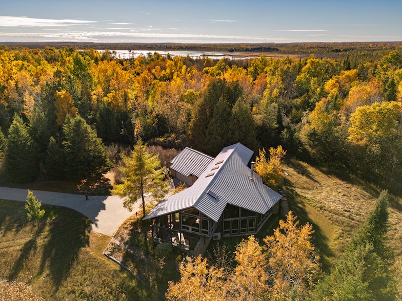 The home has a stone and cedar exterior with a metal roof. (Kevin Nordahl)