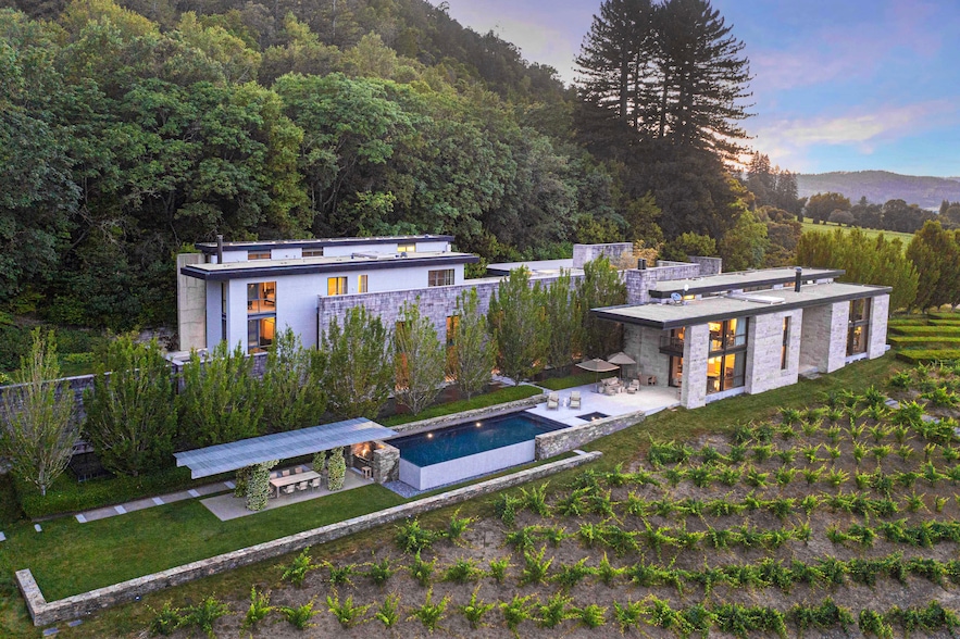 Tucked between a vineyard and the hillside, the house and grounds have a distinctly elongated arrangement. (Robert Vente)