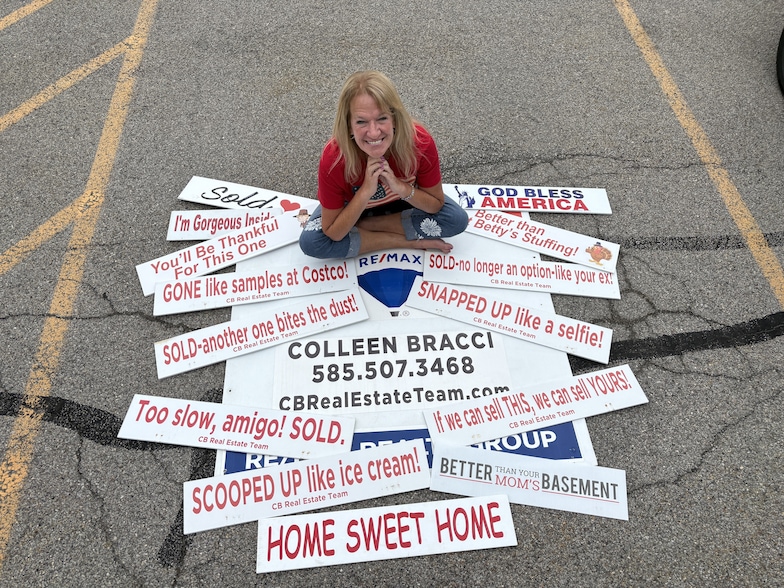 Colleen Bracci is a real estate agent in Rochester, New York, who puts jokes atop her yard signs to advertise her ReMax brokerage. (Erin Scarlata)