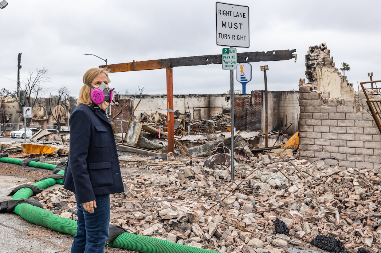 Real estate agent Teresa Fuller stands in front of her office building that was decimated by the Eaton Fire. (Kalina Mondzholovska/CoStar)