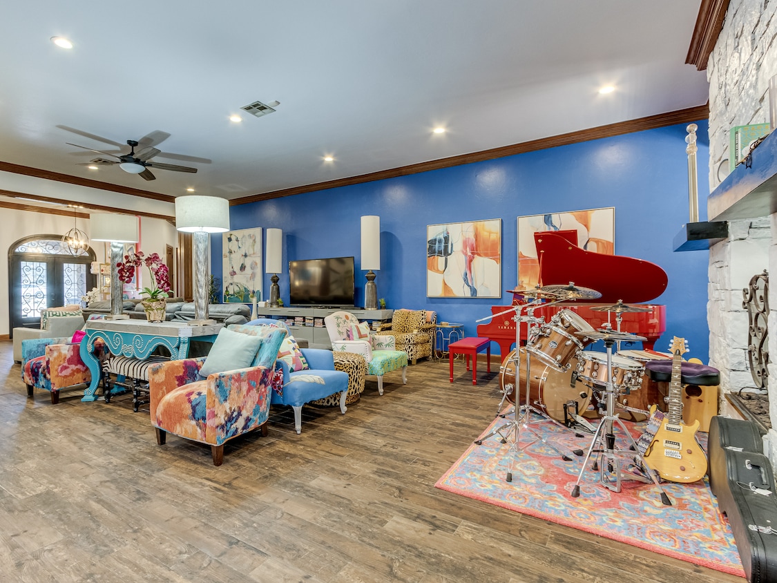 The Oklahoma City home features vibrant colors and a bold style. Singer Elton John owned and signed the red piano seen above, according to the owner. The piano is for sale, too, but doesn't convey with the house. (Brad Falkner/PEAK Real Estate Services)